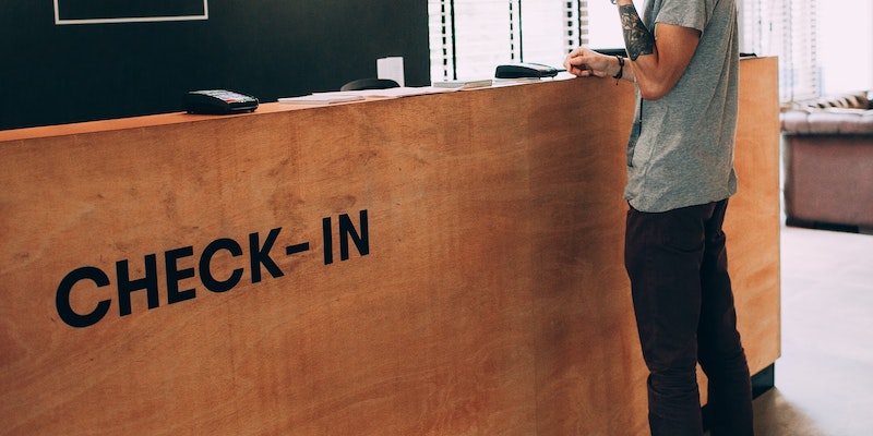 student-at-front-desk-waiting-for-receptionist